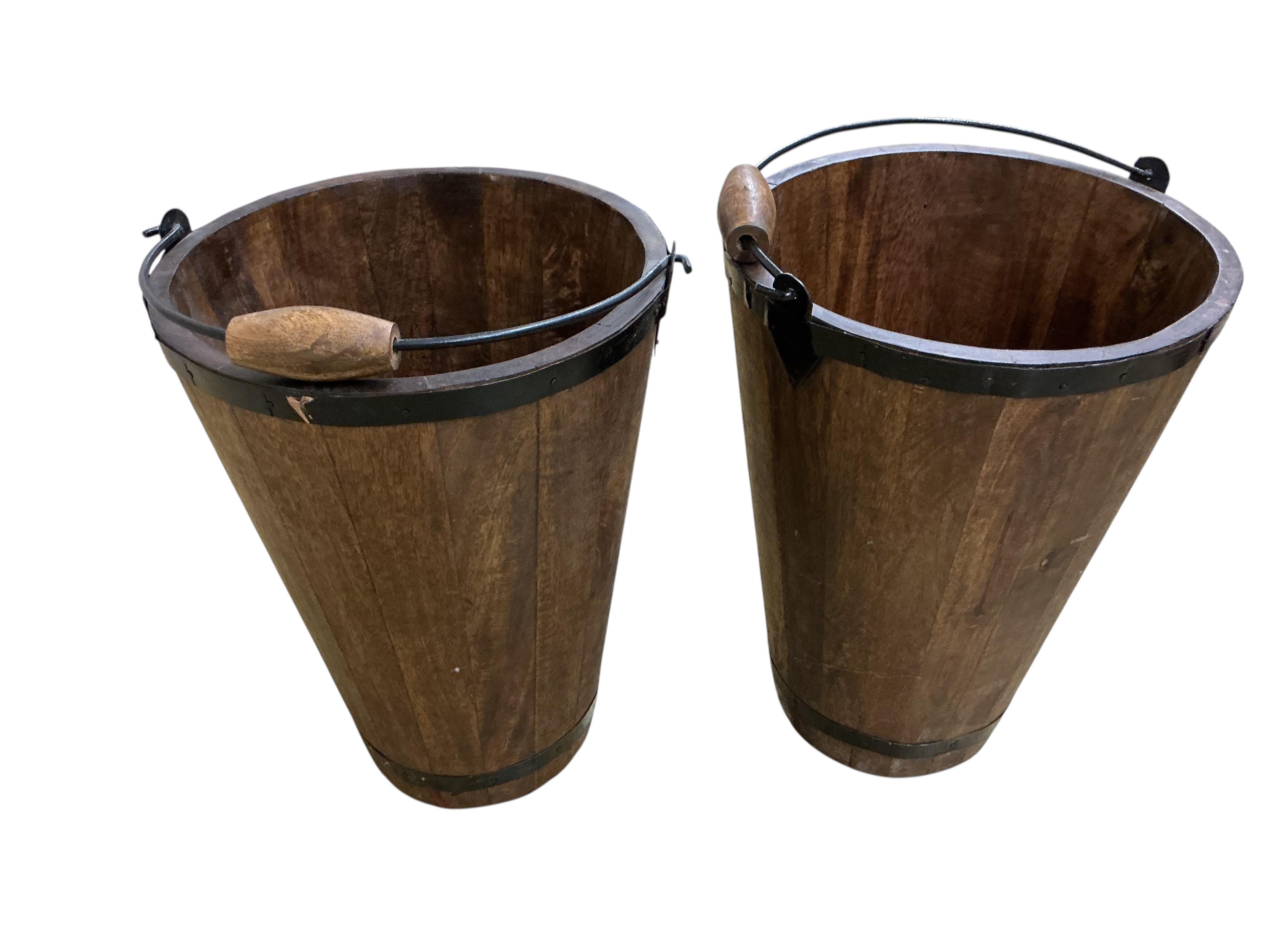 A pair of staved wood champagne buckets stencilled “Bollinger”, height 39cm.